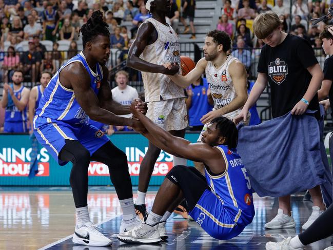 GOLD COAST, AUSTRALIA - SEPTEMBER 14: James Batemon of the Bullets is helped up by teammate Casey Prather during the 2024 NBL Blitz match between Brisbane Bullets and Cairns Taipans at Gold Coast Sports and Leisure Centre on September 14, 2024 in Gold Coast, Australia. (Photo by Russell Freeman/Getty Images)