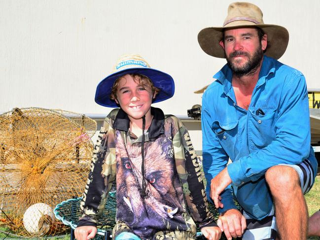 Burdekin father of three and commercial crabber Will Pearce with son Casey (left). Mr Pearce says he will be forced out of the industry by catch allocations.