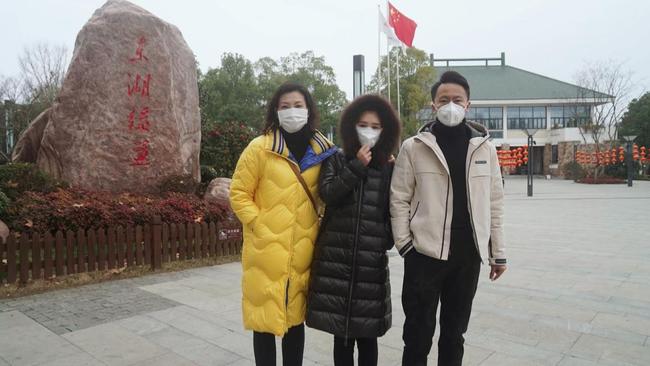 Petition organiser Zixuan Wang, centre, with family members at Wuhan's East Lake.