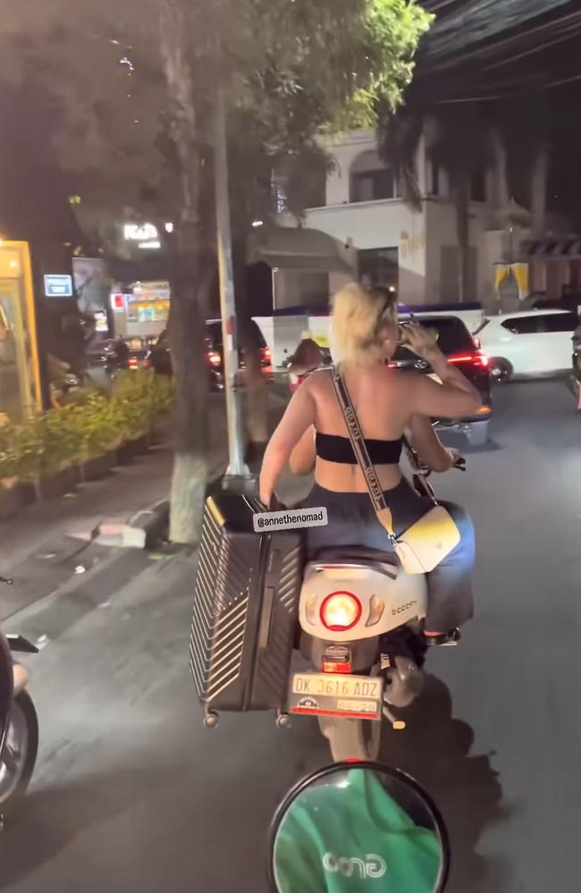 A tourist spotted on the back of a motorbike in Bali with no helmet. Picture: Instagram / @annethenomad