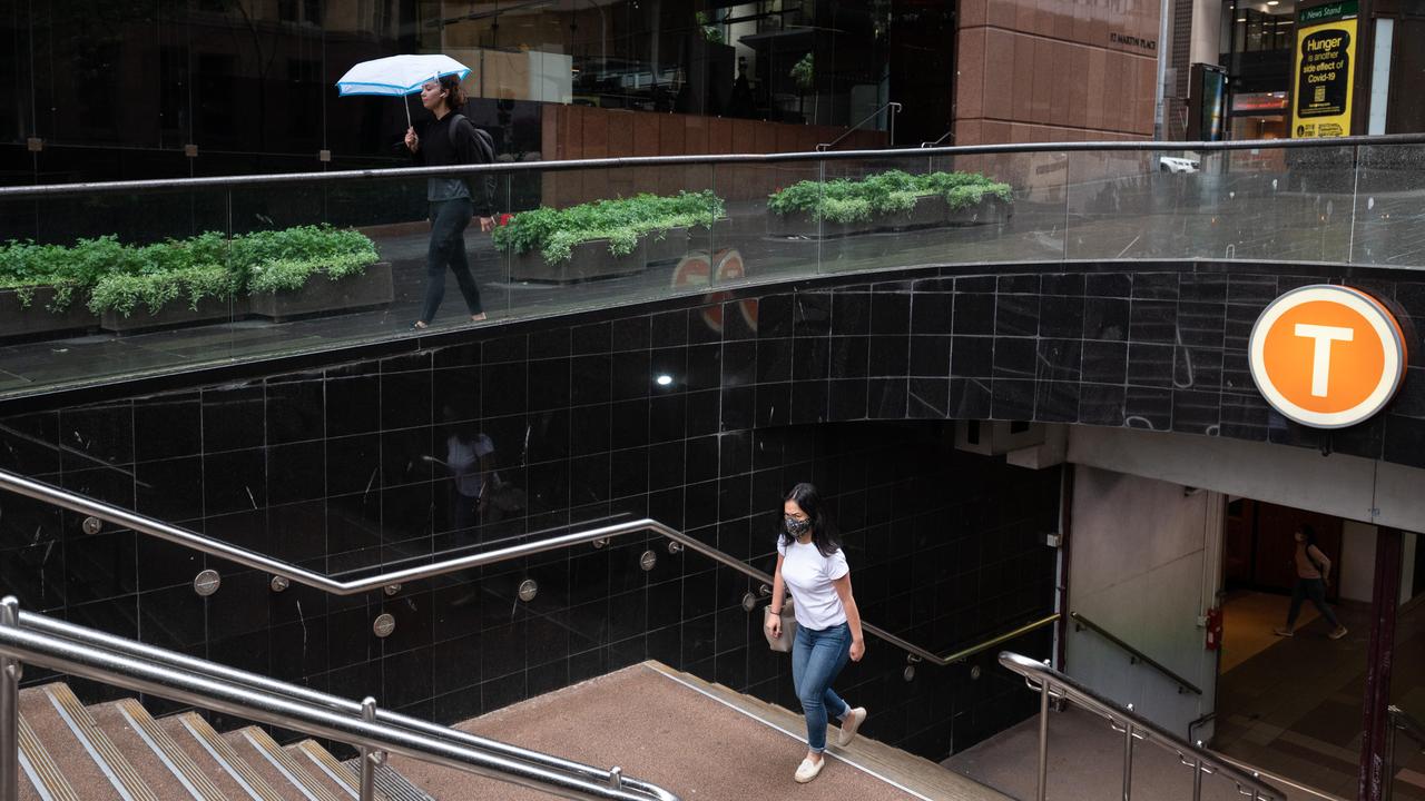 A commuter wearing a face mask at Martin Place Station, Sydney. CBDs have yet to recover as workers stay home. Picture: NCA NewsWire / James Gourley