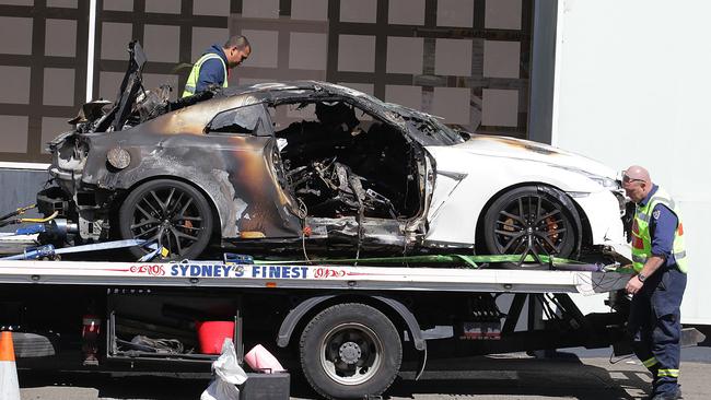 The burnt-out car is taken from the scene of a fatal car crash on Harbour Street, Darling Harbour.