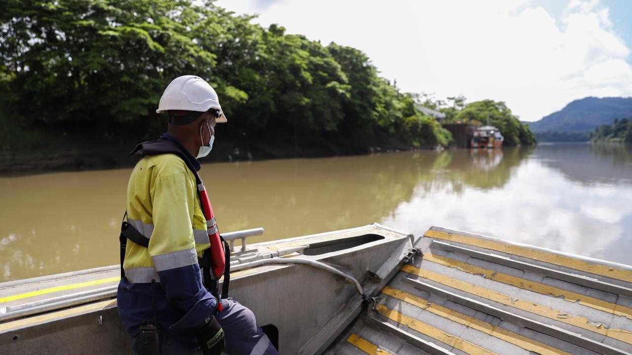 A TotalEnergies worker on the Purari River, one of the only ways in and out of Herd Base which will be the staging ground for the Papua LNG project.