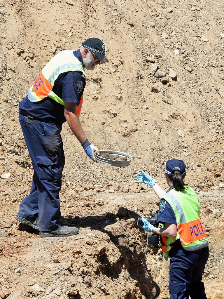 SA Police officers examine material in the pit in 2018. Picture: Greg Higgs