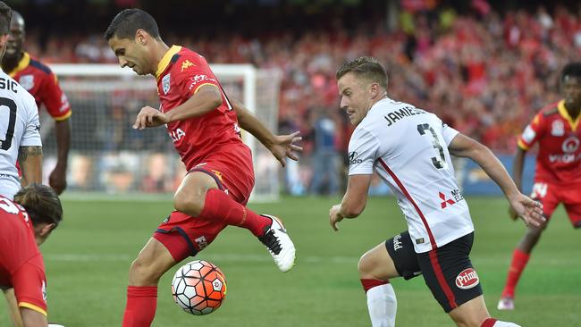 Scott Jamieson chases the ball against Marcelo Carrusca of Adelaide United on Sunday. Picture: AAP