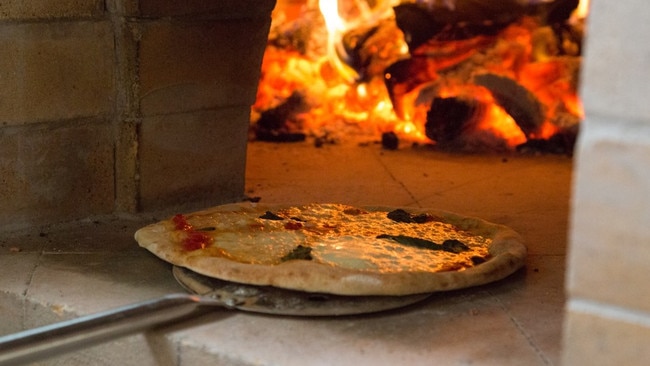 Pizza going into the oven at Lost in a Forest.