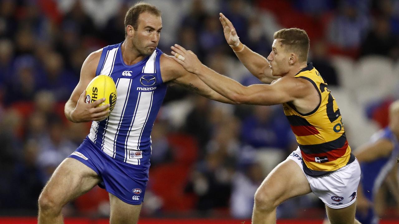 Ben Cunnington fends off Rory Laird during the clash — but it was his bump on the Crows onballer that saw him initially banned for a week. Picture: Getty Images