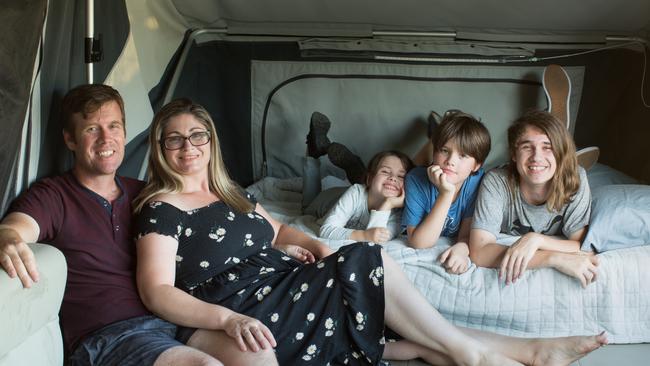 Claire and Nathan Collyer with children Eloise, 6, William, 10, and Heath, 15, inside their second-hand camper trailer. Picture: Supplied