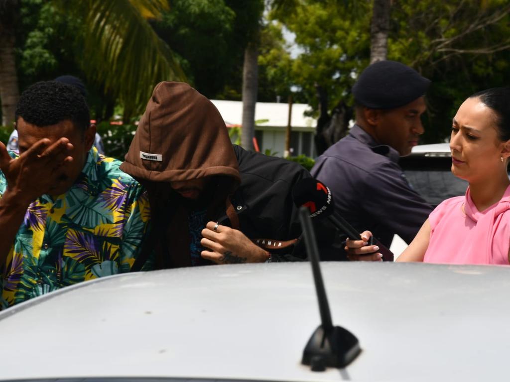 Ilaisa Tanoa Degei, 24, is escorted from a police vehicle to a holding cell at Nadi Magistrate's Court on Monday. He is pictured left.