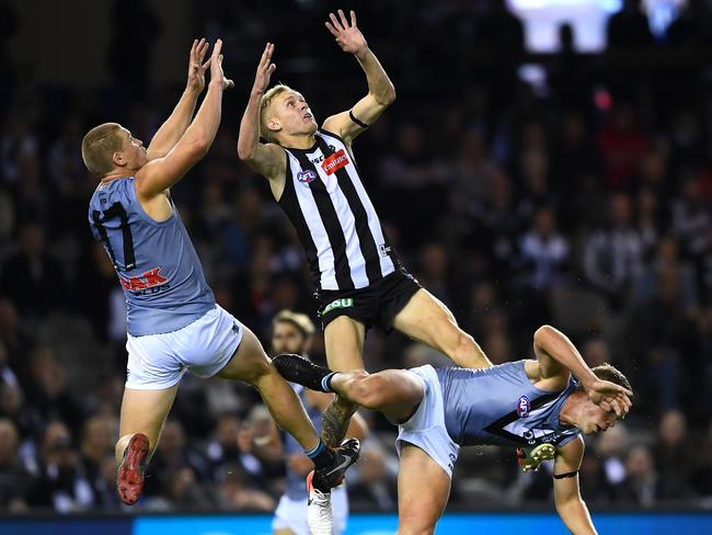  Tom Clurey of the Power and Jaidyn Stephenson of the Magpies compete for a mark. Photo: Quinn Rooney/Getty Images