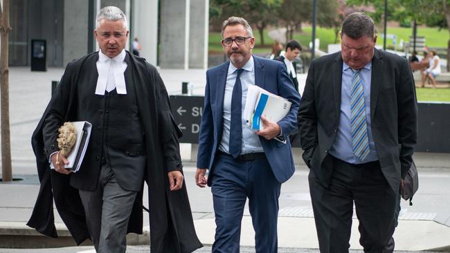 William Shuck, right, leaves Brisbane District Court with his legal counsel. Picture: Brad Fleet