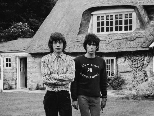 British musicians Mich Jagger (left) and Keith Richards of the rock group The Rolling Stones walk in the garden of Redlands, Richards' Sussex house, after the disclosure of their sentences for drug violations, England, July 5, 1967. Jagger received three months for possession of four Italian pep pills and Richards recieved 12 months for allowing his home to be used for smoking Indian hemp. (Photo by Hulton Archive/Getty Images)