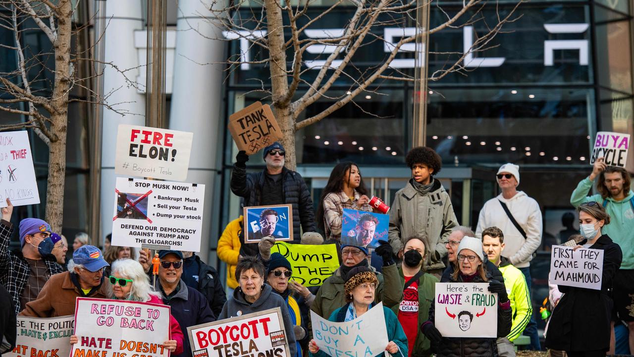 Protesters hold signs and sing chants during a protest against Elon Musk and his Tesla car company outside the Tesla dealership in Boston, Massachusetts on March 15, 2025. Picture: Joseph Prezioso / AFP