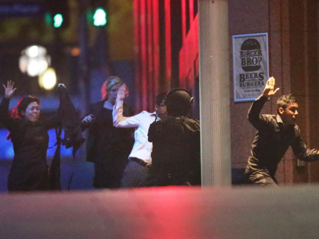The remaining hostages run to safety at the end of the siege. Picture: Bill Hearne