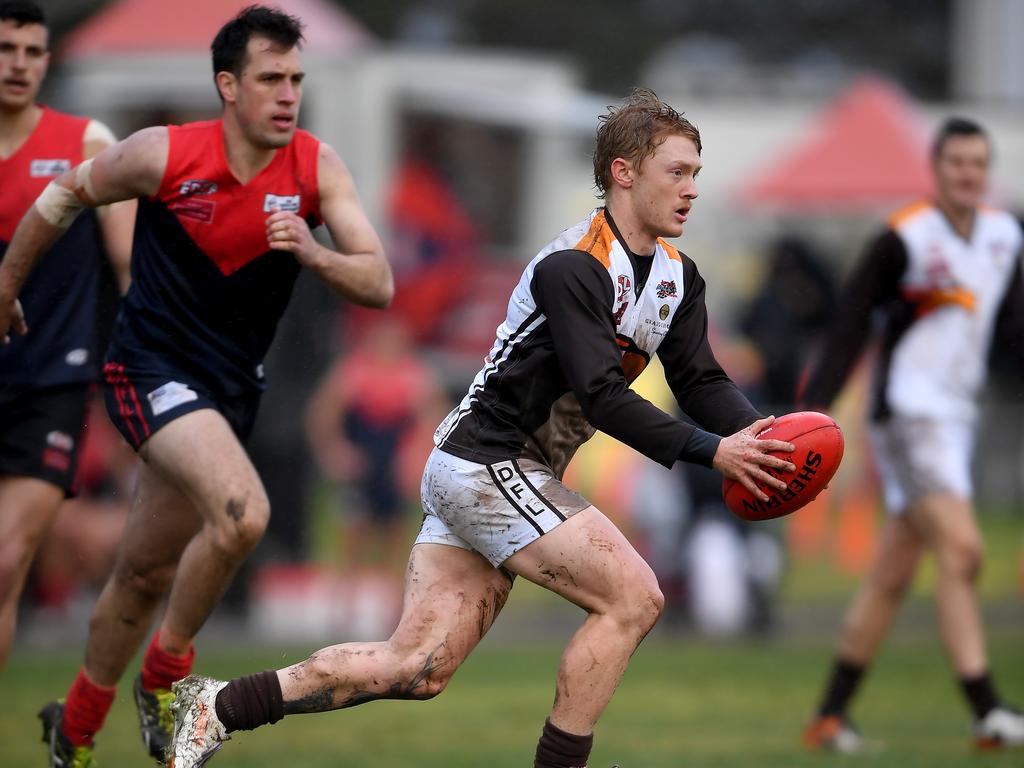 A muddied Caelan Anderson surges forward for Craigieburn against Tullamarine. Picture: Andy Brownbill