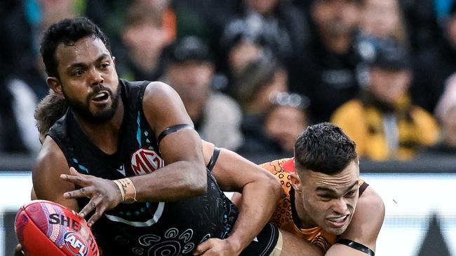 ADELAIDE, AUSTRALIA - MAY 19:   Willie Rioli of the Power   tackled by  Karl Amon of the Hawks during the round 10 AFL match between Yartapuulti (the Port Adelaide Power) and Hawthorn Hawks at Adelaide Oval, on May 19, 2024, in Adelaide, Australia. (Photo by Mark Brake/Getty Images)