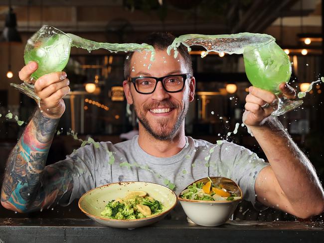 Stomping Ground Brewing Co manager and certified cicerone Matt Marinich with some vegetarian meals and a green beer. Picture: Alex Coppel