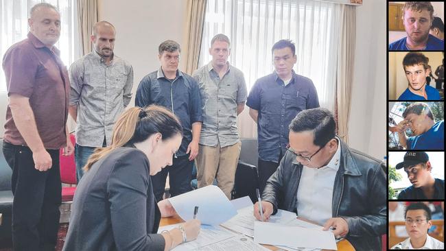 The five members of the Bali Nine watch as Australian diplomat Lauren Richardson signs the paperwork for their return home on Sunday. Picture: Indonesian government