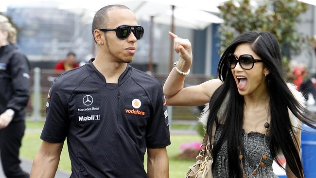 Hamilton and girlfriend Nicole Scherzinger of the Pussycat Dolls, right, arrive at the Albert Park circuit in Melbourne in 2011. Photo: AP Photo/Vincent Thian