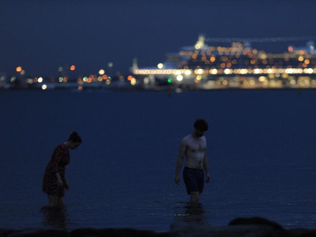 People escaping the heat enjoy a swim at Middle Park Beach. Picture: Andrew Henshaw