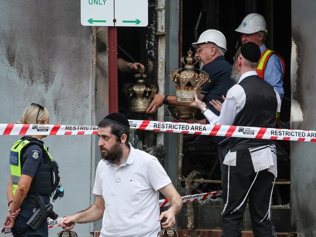 MELBOURNE, AUSTRALIA. NewsWire Photos. 6 DECEMBER, 2024. The Adass Israel Synagogue, an ultra orthodox synagogue in Ripponlea, was attacked about 4am on Friday December 6, No one was injured during the incident, but the synagogue sustained significant damage. Members of the Jewish community remove religious artefacts from the burnt remains of their Synagogue.  Picture: NewsWire/David Caird