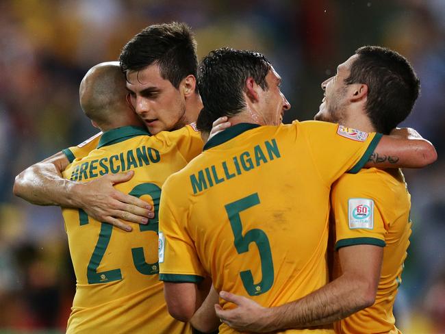 Tomi Juric celebrates his goal with Mark Bresciano, Mark Milligan and Matthew Leckie in the Socceroos match against Oman.