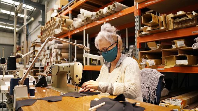 A worker uses a sewing machine to sew face masks at a Carrum Downs factory based in Melbourne.