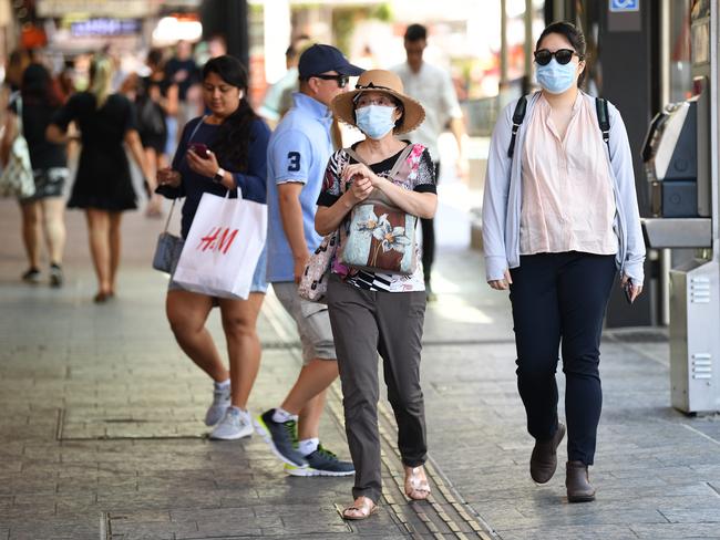 BRISBANE, AUSTRALIA - NewsWire Photos - DECEMBER 23, 2020.Mask-wearing women walk through a shopping district in central Brisbane. Retailers enjoy a brief boom in sales at the end an otherwise brutal business year.Picture: NCA NewsWire / Dan Peled