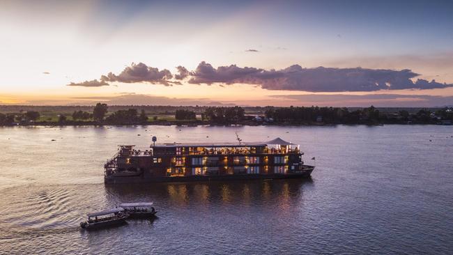 The river cruise ship Aqua Mekong on Tonle Sap River at dusk.