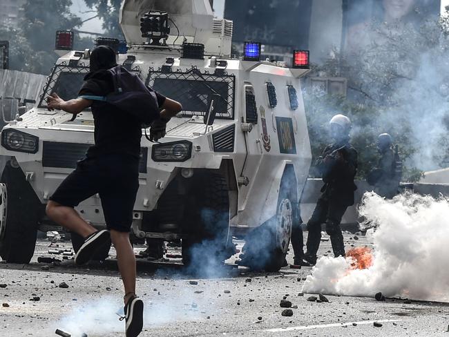 An opposition activist clashes with the riot police during a march against Venezuelan President Nicolas Maduro held on May Day, in Caracas. Picture: Juan Barreto/AFP