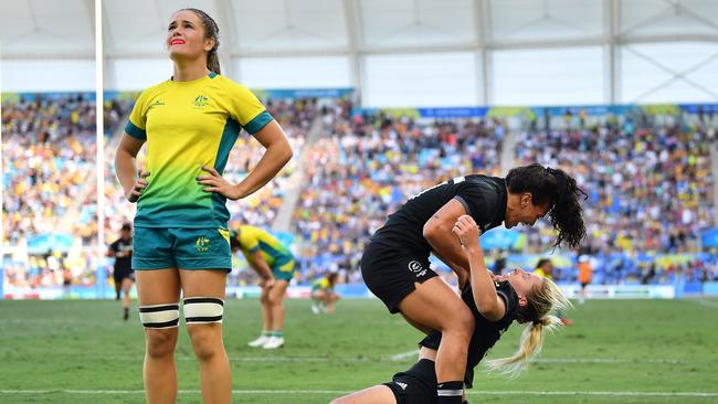 New Zealand’s Kelly Brazier (8) is congratulated by Portia Woodman after scoring the winning try in the Women's Gold Medal Rugby Sevens Match.