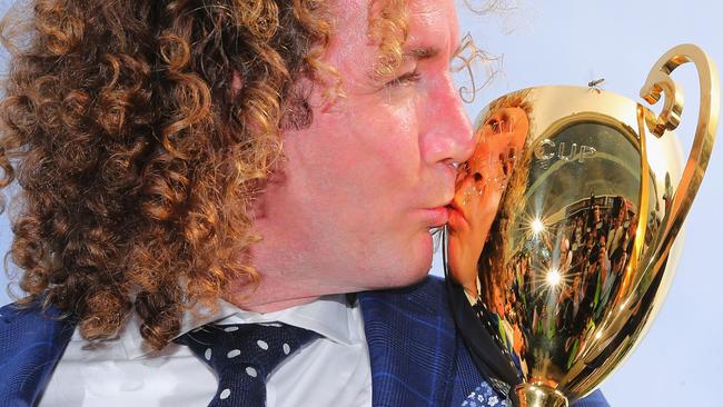 Trainer Ciaron Maher shows off the spoils of victory.