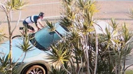 The cyclist (top left) passing the woman's vehicle parked on the street. Picture: Facebook