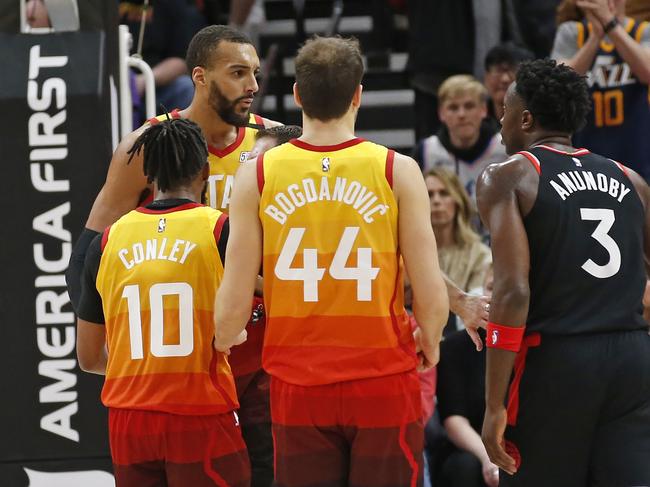 Utah Jazz center Rudy Gobert, rear, is separated from Toronto Raptors forward OG Anunoby (3) in the second half of an NBA basketball game, Monday, March 9, 2020, in Salt Lake City. (AP Photo/Rick Bowmer)