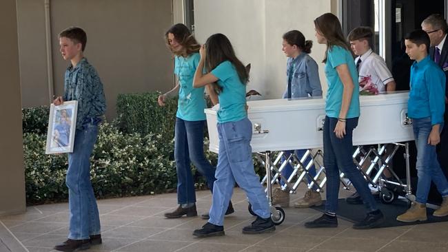 Friends carry Giselle’s casket out of the church.