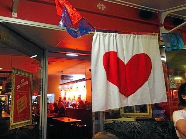 Red hearts are being made and hung at business all around Lismore flagging the town's resilience and survival after the floods. Picture: Rebekka Battista