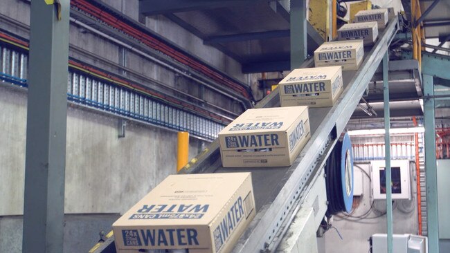 These packs of water at the CUB brewery in Tassie will be similar to those which will be stacked at the Yatala brewery before they are ready to be taken by truck to areas where there is no fresh drinking water.