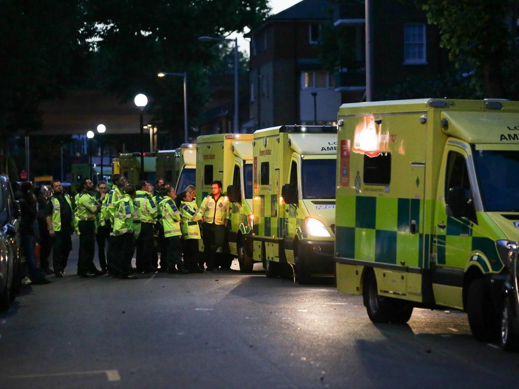 Ambulances stationed near the huge fire engulfing the Grenfell Tower early June 14, 2017 in west London. Picture:AFP Photo/Daniel Leal-Olivas