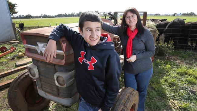 Santo Celi, 14, with his mum Maria at their home in Leeton, NSW. Santo was diagnosed with cancer just before he turned eight