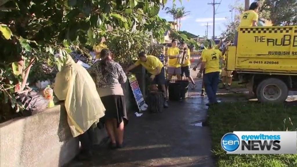 Bobolas family look on as police attempt to clean-up front yard