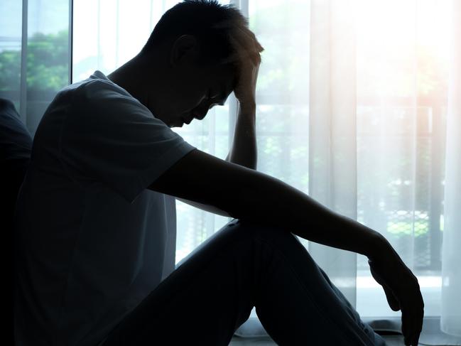 The man sitting in the corner of the room has emotional and mental problems He has depression and stress from society and work. medical concept. stress causes lots of problems to the body