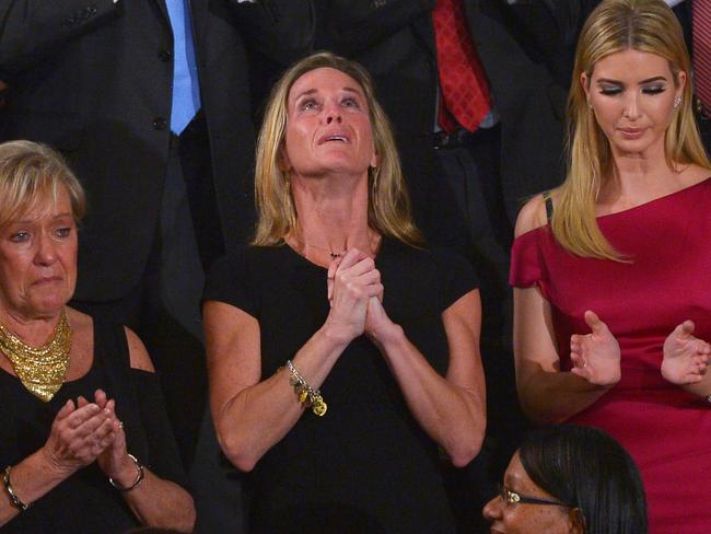 Carryn Owens, wife of slain Navy SEAL William Owens, looks up while being acknowledged by President Trump during his address.