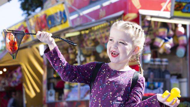 Charlotte Owttrim enjoys 'catch a fish' game at the Redcliffe Show in 2019. PHOTO: AAP /Renae Droop