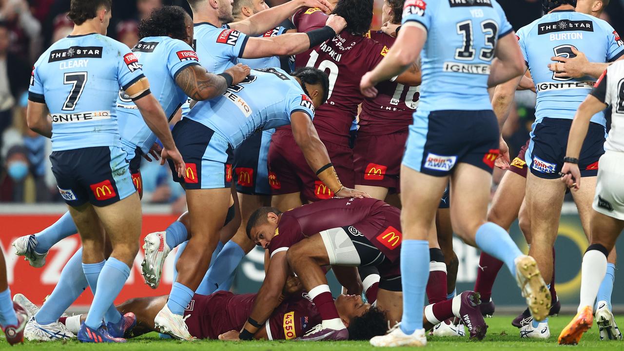 Dane Gagai protects Selwyn Cobbo from a melee after the winger was knocked out in a tackle. Picture: Chris Hyde/Getty Images