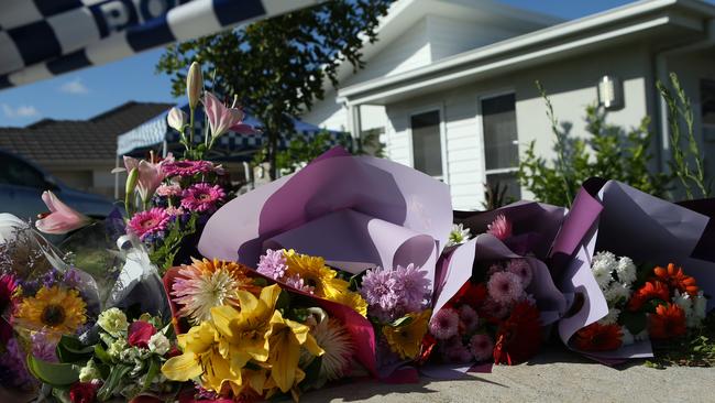 Flower’s left at Ms Bradford’s home where she was killed. Picture by Scott Fletcher