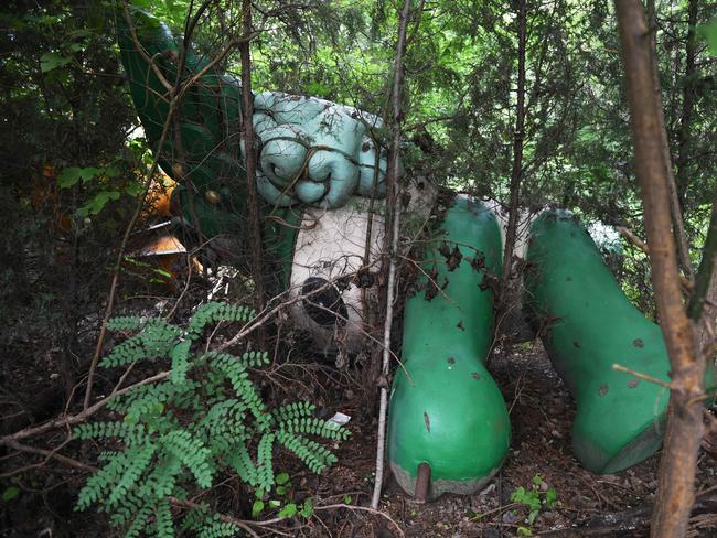 Nini, one of the games’ five mascots, lays abandoned behind a never-completed shopping centre.