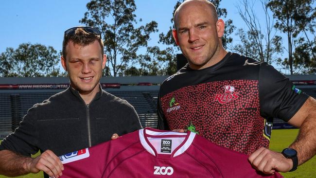 Jeff Horn is presented with a Reds jersey by captain Stephen Moore. Photo: Brendan Hertel, QRU