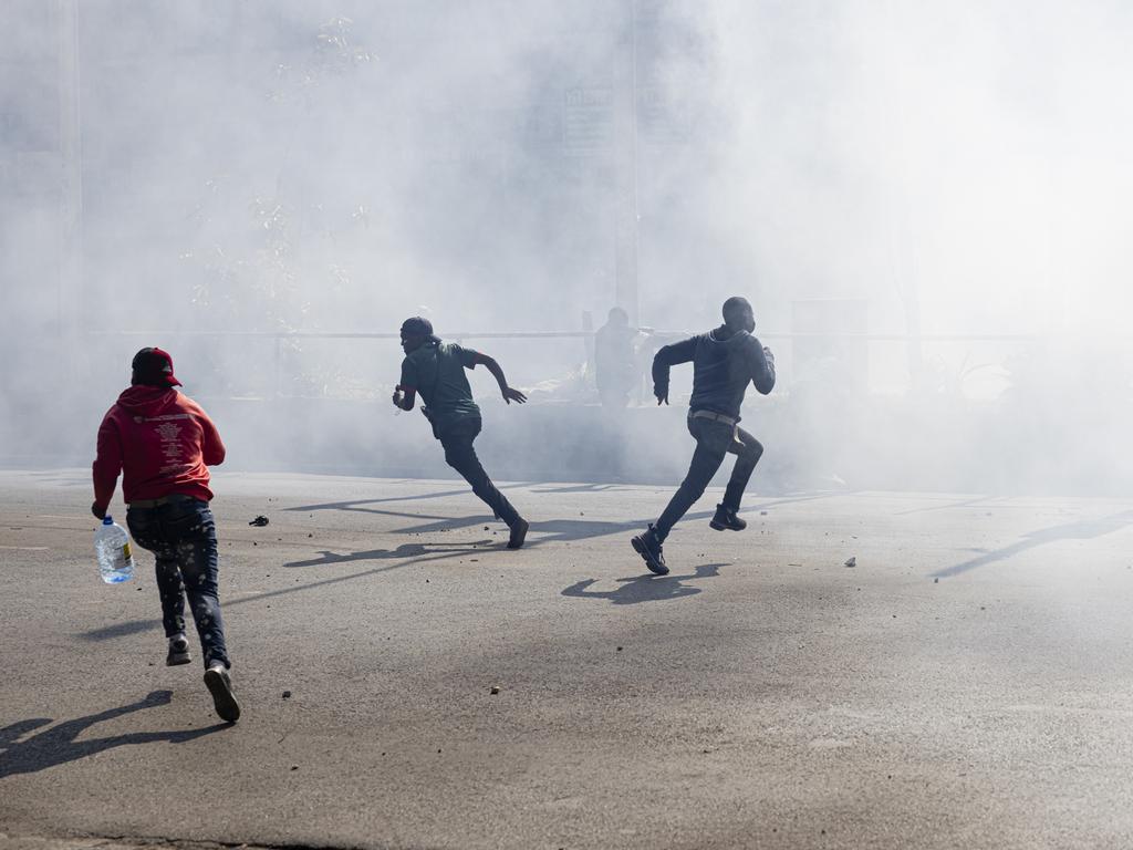 Crowds threw stones at police, broke through barricades, and entered the parliament grounds.