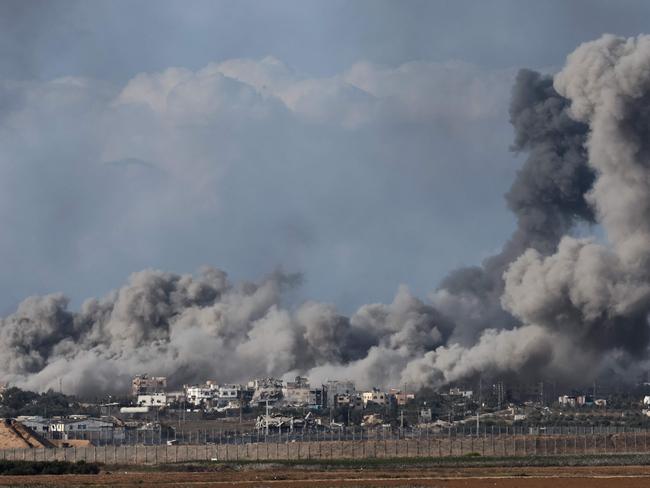 TOPSHOT - A picture taken from southern Israel near the border with the Gaza Strip on December 9, 2023, shows smoke rising during an Israeli strike in Gaza amid ongoing battles with the Palestinian Hamas militant group. (Photo by JACK GUEZ / AFP)