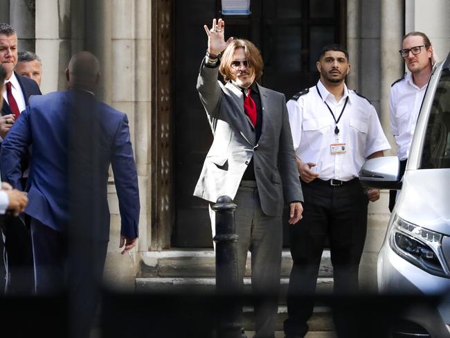 Johnny Depp acknowledges fans outside court. Picture: Getty